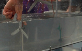 Hand pushing a propeller under water